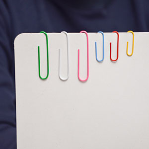 Paper clips attached with paper to show different sizes available in same deal