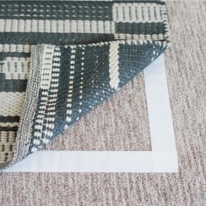 Rug peeled back showing tape on floor