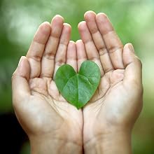 Two hands gently holding a heart-shaped leaf