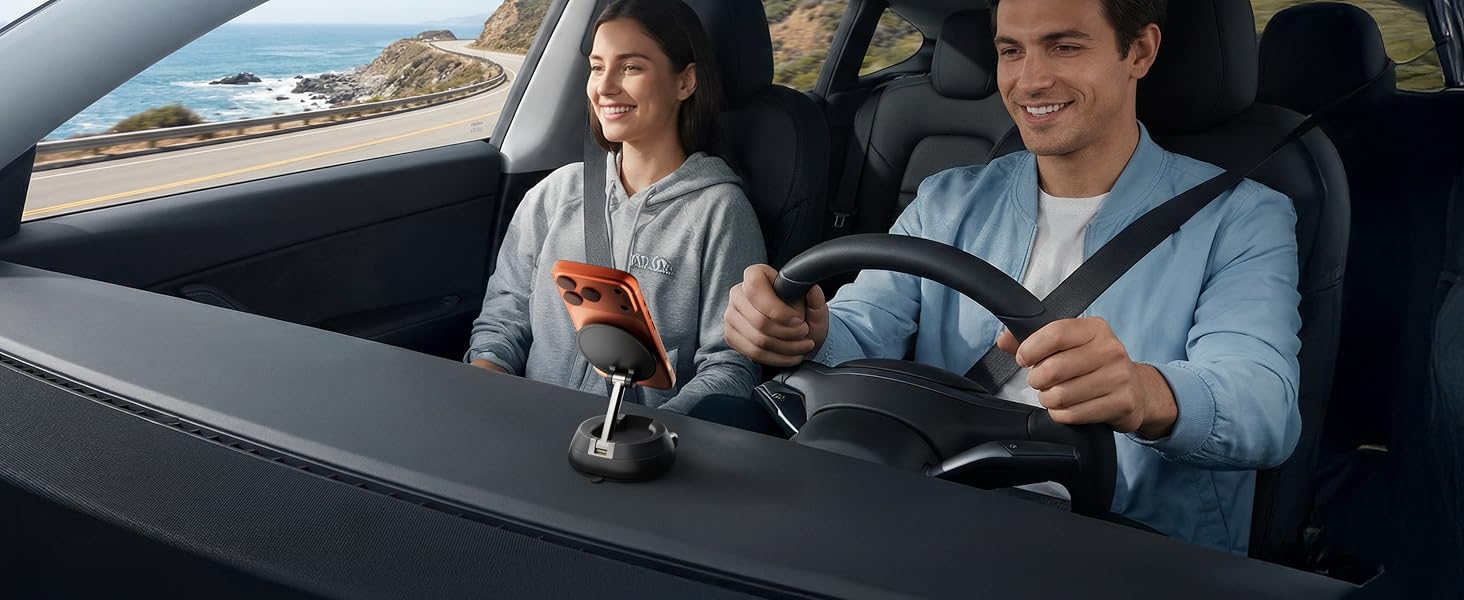 Happy couple using a secure dashboard car phone mount for navigation on a road trip.