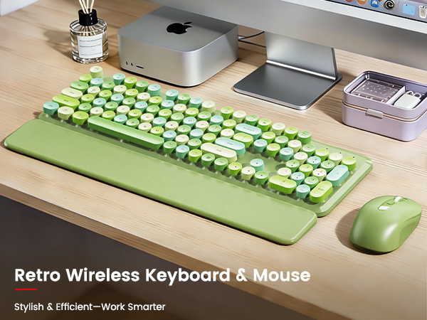 Green retro keyboard and mouse with wrist rest on a clean wooden desk setup