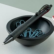 Photo shows G2 Edge pen resting on a desk's tiny bowl of paperclips