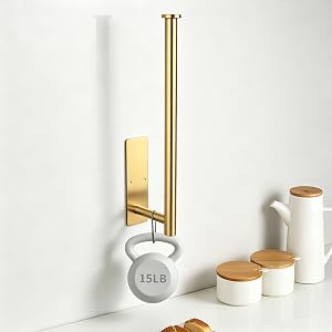 Text reads '15LB'. Styled product display featuring brass and white cylindrical containers with cork lids, a brass vertical pole stand, and a white spherical weight marked '15LB' on minimalist white background.