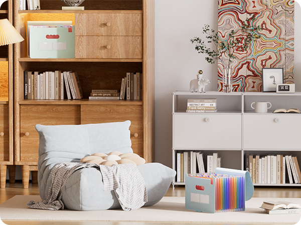 Organized bedroom storage scene with wooden bookshelf, floor cushion setup, and storage boxes. Features mint green storage container and multicolored accordion file.