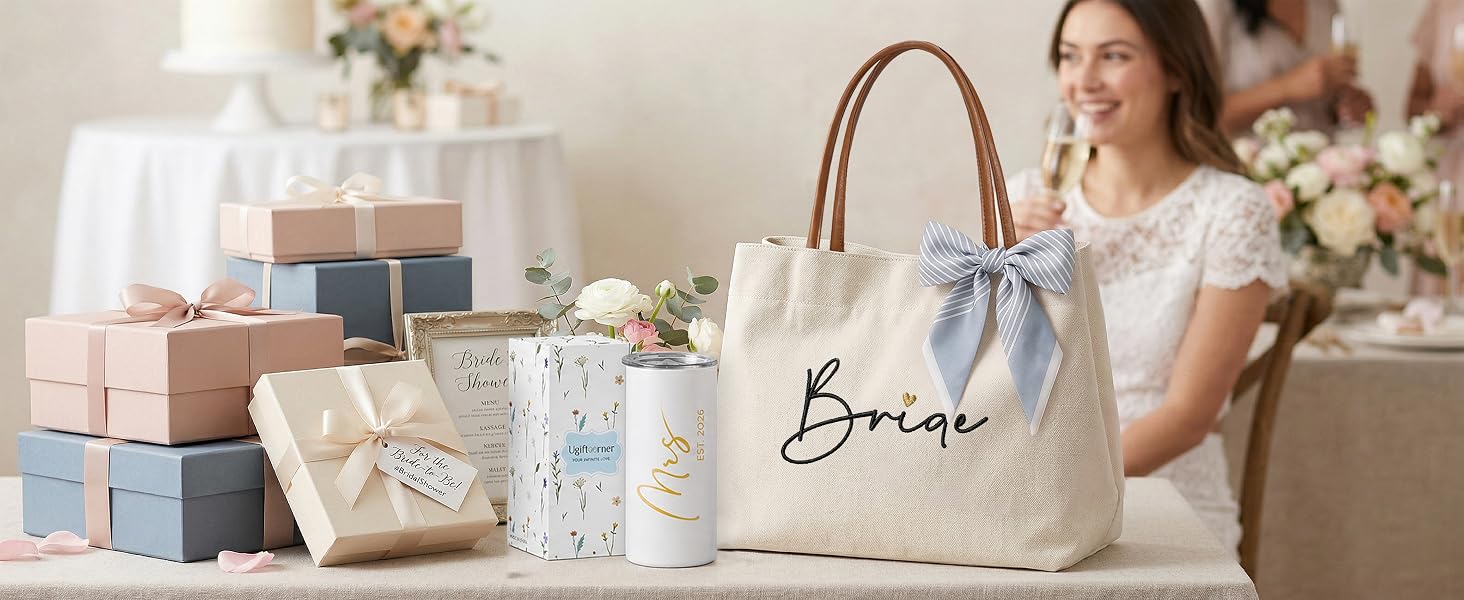 An embroidered Bride tote bag displayed on a table with flowers and bridal shower gift boxes