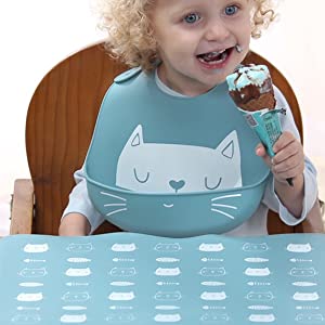 a baby is wearing our bib eating an ice cream