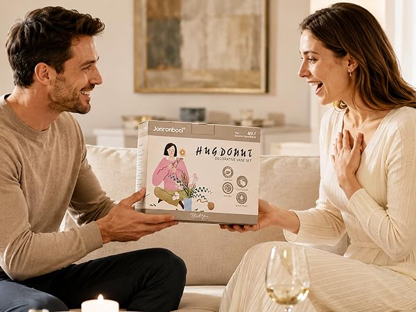 Man gives vase gift box to woman.
