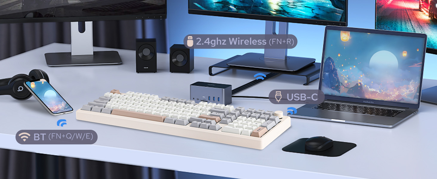 a desk with a keyboard, mouse, speakers, and a monitor.