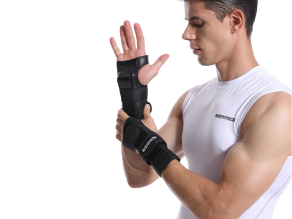 Man adjusting wrist guard