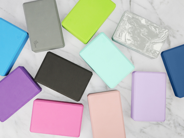 Collection of rectangular phone cases or card holders arranged on marble surface, displayed in various pastel and solid colors including pink, purple, blue, mint green, and black.