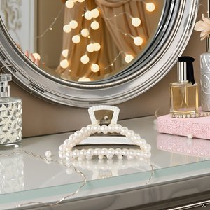 A vanity table with various hair accessories, including brushes, combs, and the product displayed pr