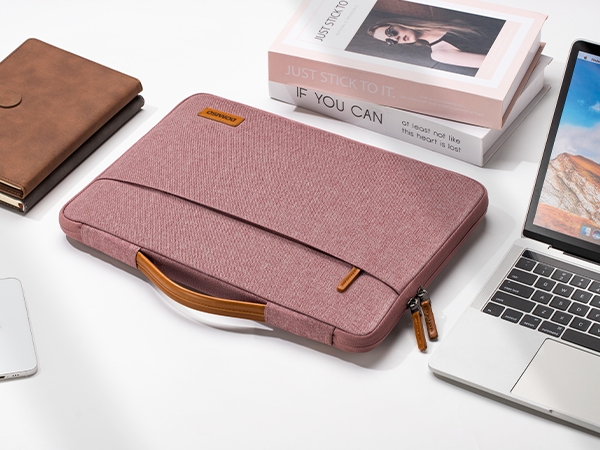 Multiple views of pink laptop sleeve or case with brown leather accents. Product shown with laptop and in various angles demonstrating storage capacity and design features.