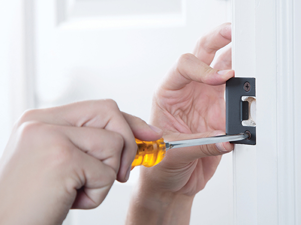 Woman easily installing door hardware for handle, knob or lever with just a screwdriver