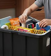 Person organizing snacks and supplies in black tote with yellow dividers