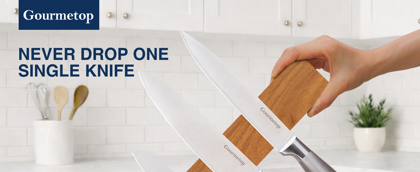 Acacia wood magnetic knife holder mounted on wall holding kitchen knives