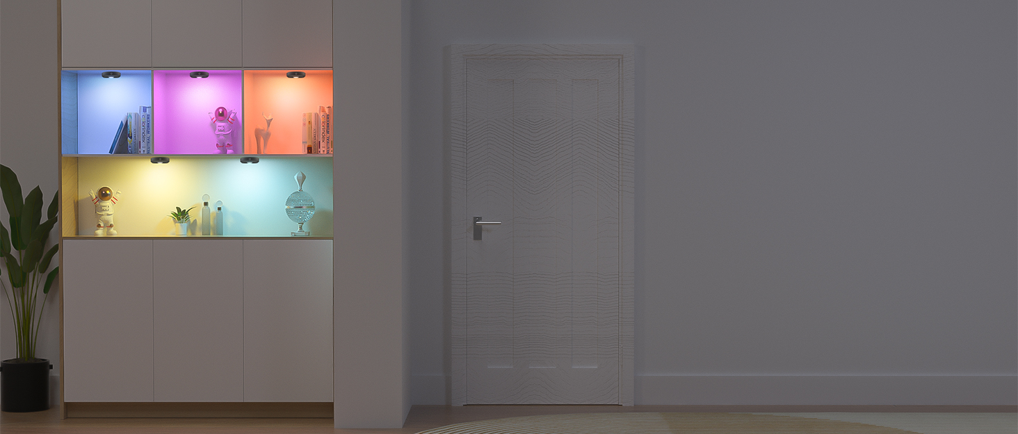 Wall-mounted display featuring multiple square panels with different colored ambient lighting, mounted above white cabinet furniture.