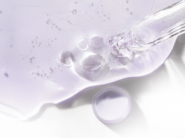 Closeup of dropper & serum particle next to information related to Biotin and its benefits.