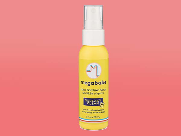 Hand sanitizer spray on red background.