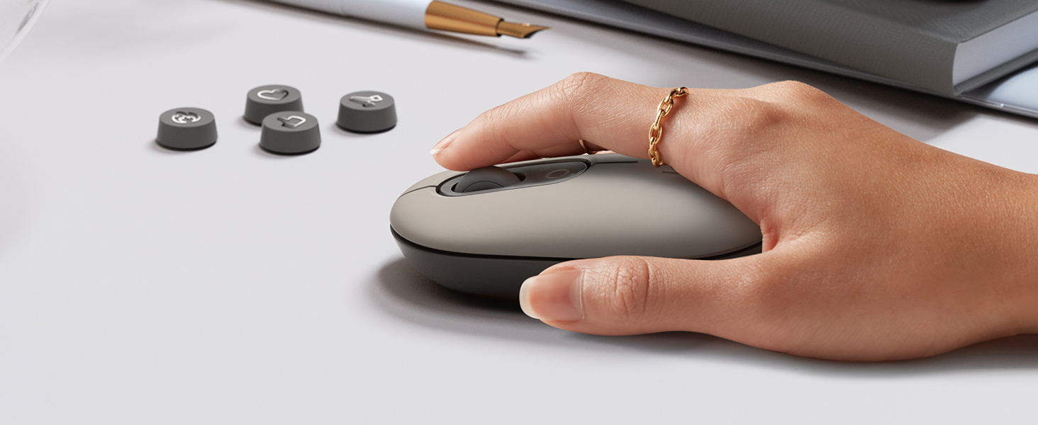 a woman using pop mouse mist wireless beige gray mouse