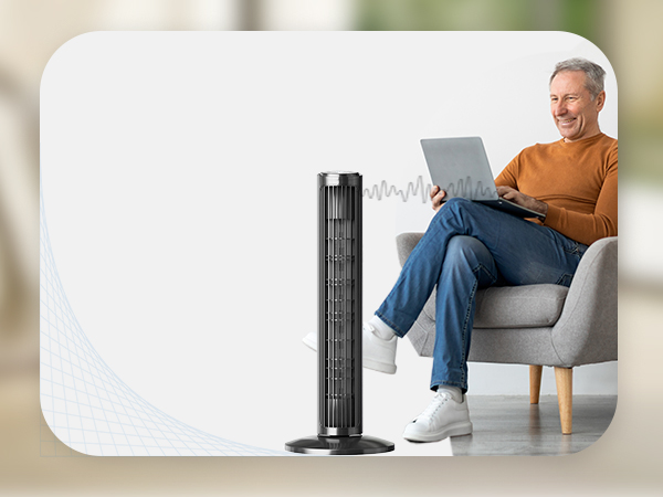 guy silling on the computer with fan blowing on him