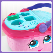 Shows a watermelon being placed in the correct shape sorter