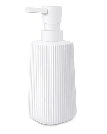 White ribbed ceramic soap or lotion dispenser bottle with pump top on white background.