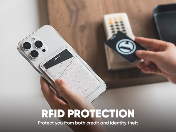 Smartphone with attached white leather card holder demonstrating RFID protection. Hand holds phone while another holds RFID-blocking card near it, illustrating theft prevention.