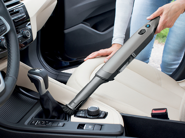 vacuuming up console on car