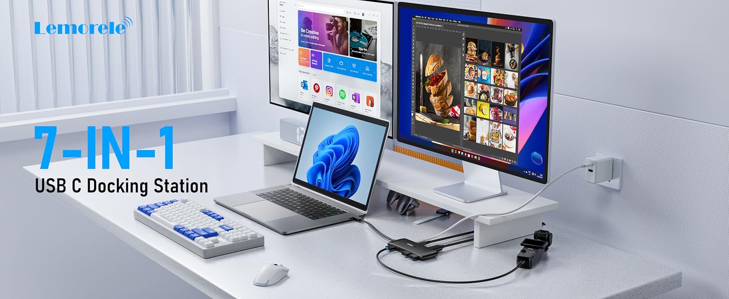 Text reads 'USB-C Docking Station'. Modern white desk setup with multiple monitors, laptop, and docking station showing connectivity options.