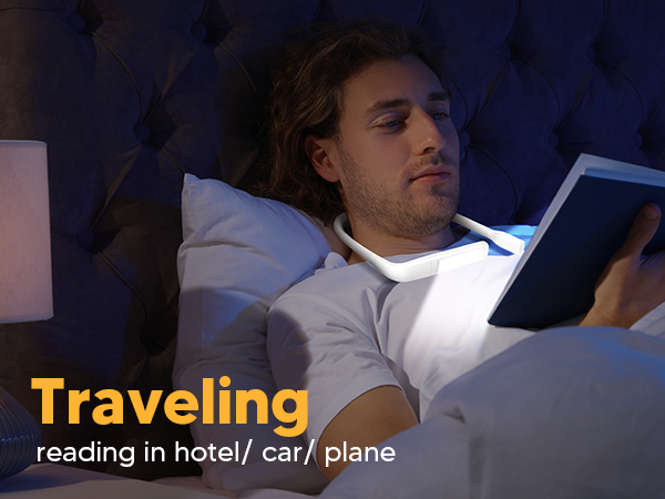 A young man is enjoying reading book in bed in the hotel room with the EastPin LED neck book light