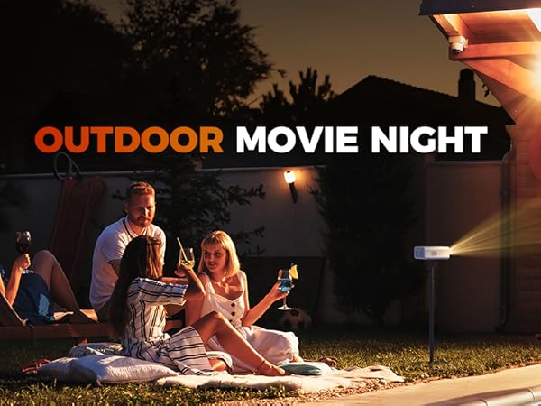 Outdoor movie night setup with projector screen showing people gathered on blankets near a pool at dusk.