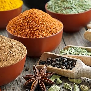 Collection of various herbal ingredients, ground-up in bowls and also in seed form