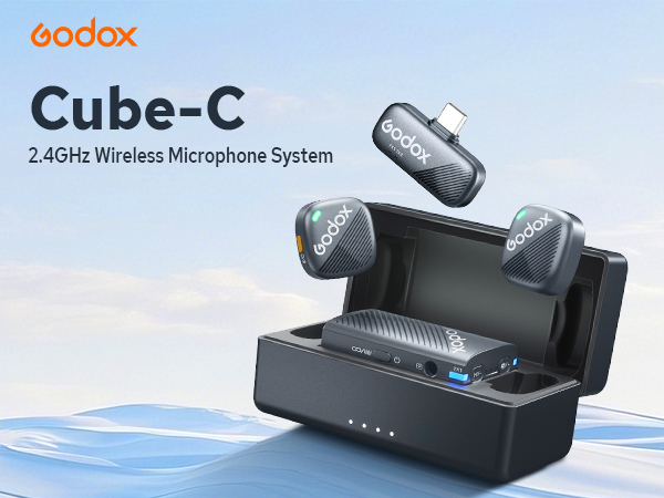 Godox Cube-C 2.4GHz wireless microphone system featuring a charging case with two microphones and a separate transmitter unit. The case displays LED indicators and a USB port.