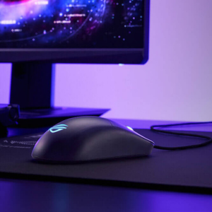 Side view of a ROG harpe ace mini on a desk next to a ROG monitor