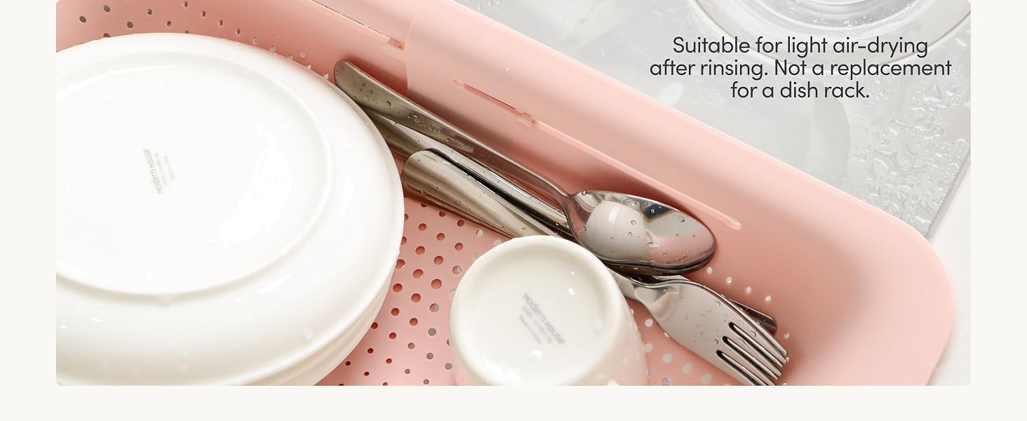 Dishes air-drying in sink colander after rinsing, not a full dish rack replacement