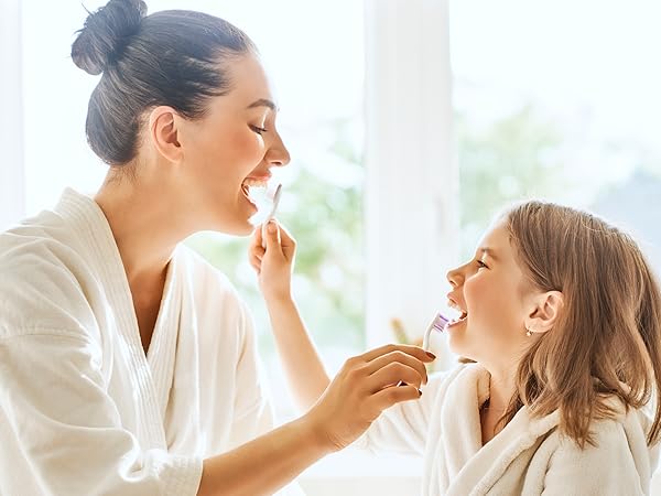 mom and daughter brushing teeth