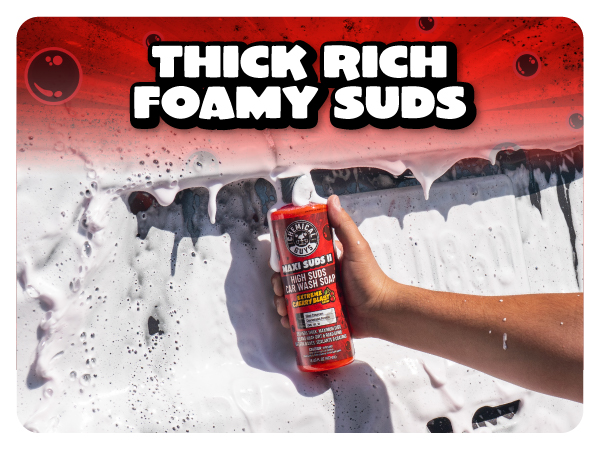 Detailer pours red Maxi Suds II shampoo into a clean wash bucket while washing a black sedan