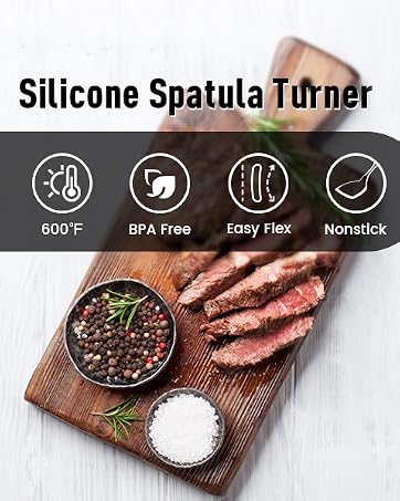 Silicone spatula turner with perforated black head and red-accented handle. Features heat resistance to 600°F, BPA-free material, easy flip design, and non-stick properties.