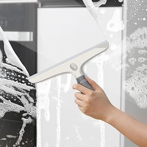 a hand holding a window cleaner with a white background