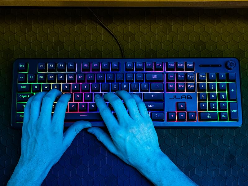 A close up view showing mans hands typing on the nightfall keyboard