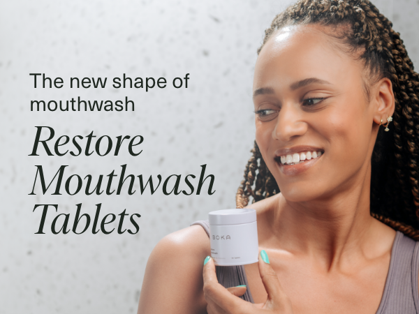 Woman using Restore Mouthwash Tablets 2-Pack