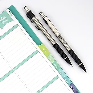 Zebra Pen, M-301 mechanical pencil close up image showing the pencil next to a notebook planner