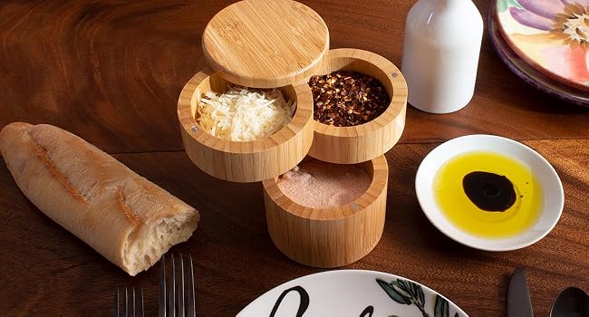 The Triple Bamboo Salt Box with magnetic Swivel on a dinning table serving a variety of spices.