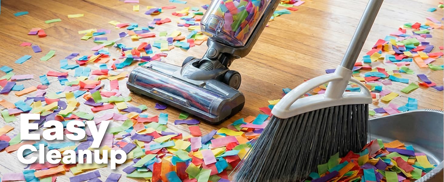 Easy cleanup of colorful confetti with vacuum cleaner, broom and dustpan on wooden floor