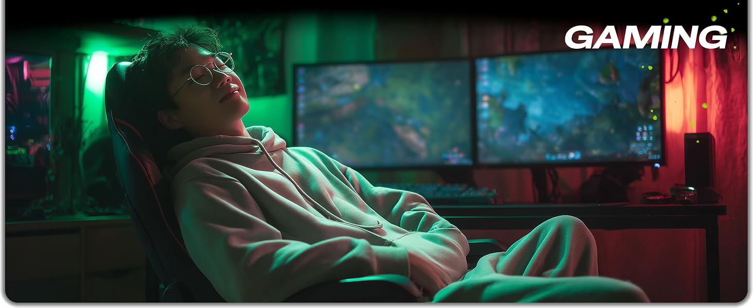 man smiling at gaming desk using ergonomic mouse pad with wrist rest support