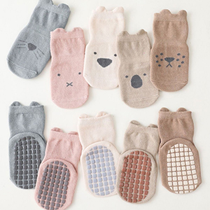 Set of cute animal-themed socks for children. Features bear, rabbit, and koala designs in pastel colors with non-slip grips on soles.