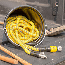 100 FT HydroTech Pro Series expandable hose in a bucket