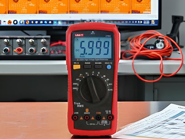 A close-up view of the product on a workbench surrounded by various electrical components and tools.