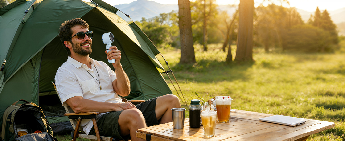 Man camping with blue rechargeable fan outdoors powerful small fan for hot summer days tent