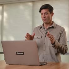 Man Speaking in a Virtual Meeting on a Laptop